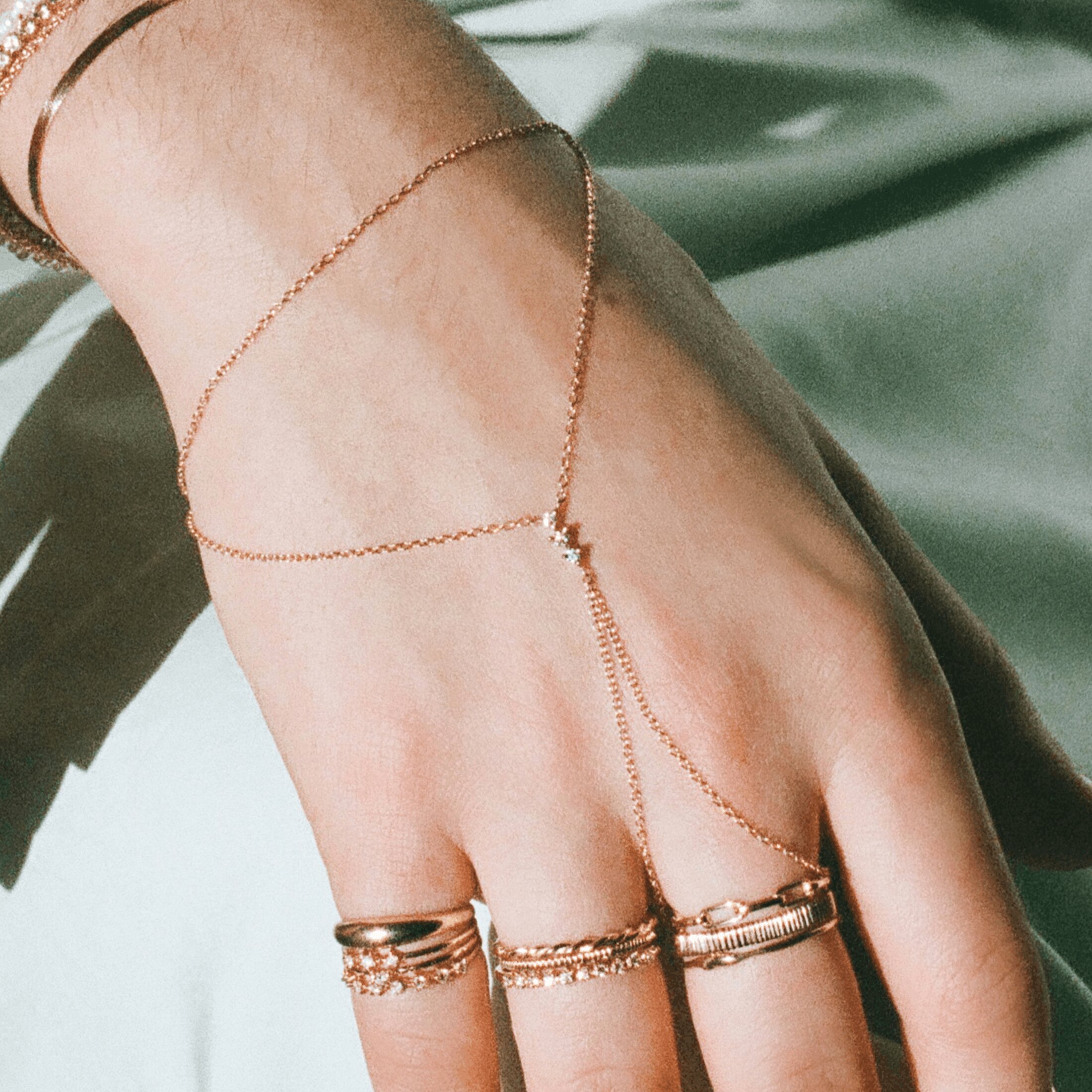 Close up with a hand with a gold hand chain 