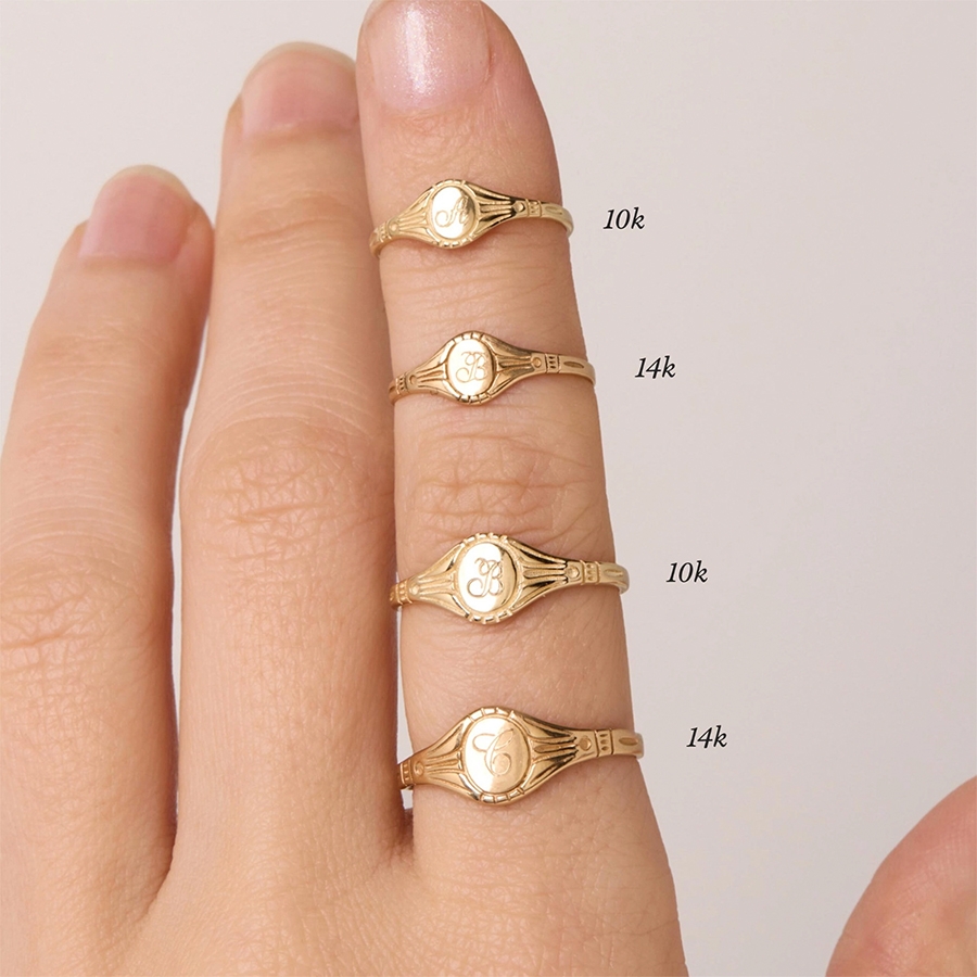 10k and 14k Gold Rings Stacked on Woman's Finger.